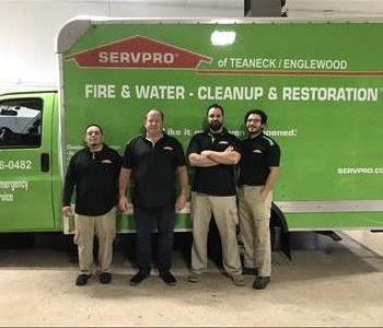 4 male employees standing in front of a SERVPRO an